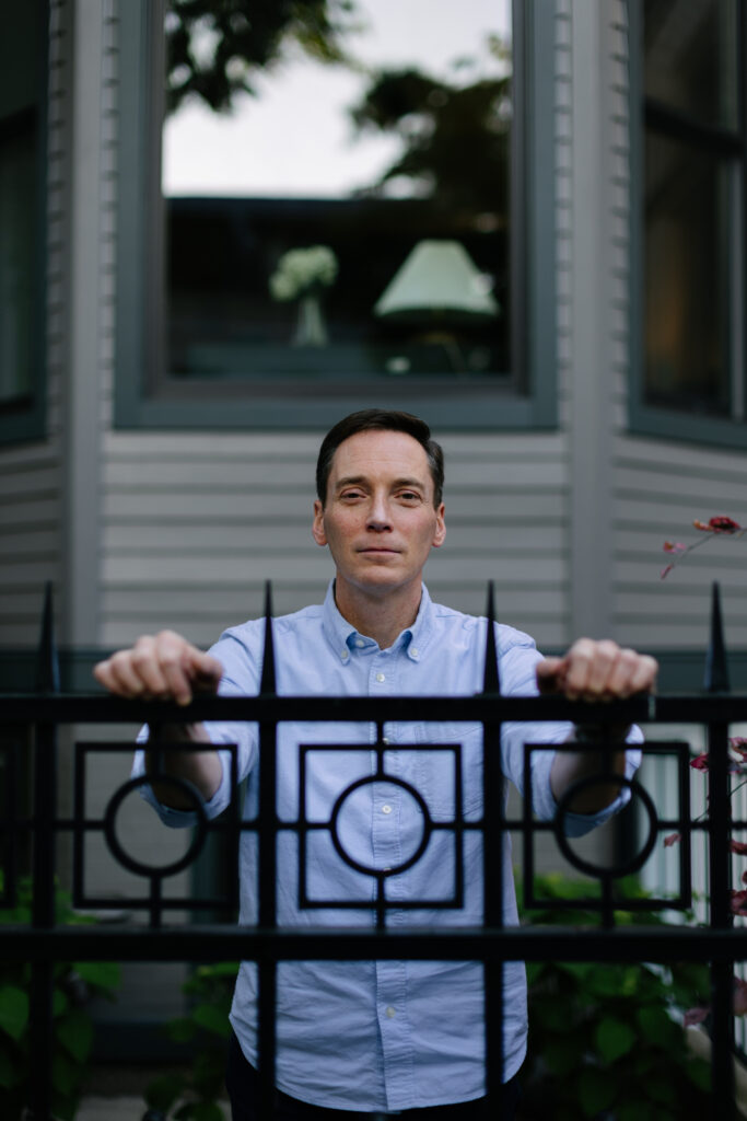 Leo Feler stands inside his fence at his home in Chicago, which was warrantlessly raided by Customs and Border Protection officers in October 2025.