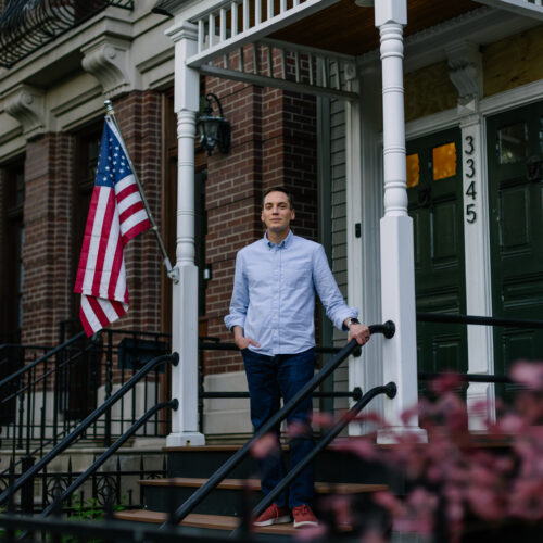 Leo Feler stands on the porch of his home in Chicago, which was warrantlessly raided by Customs and Border Protection officers in October 2025.