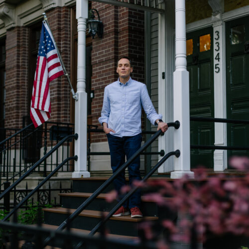 Leo Feler stands on the porch at his home in Chicago, which was warrantlessly raided by Customs and Border Protection officers in October 2025.