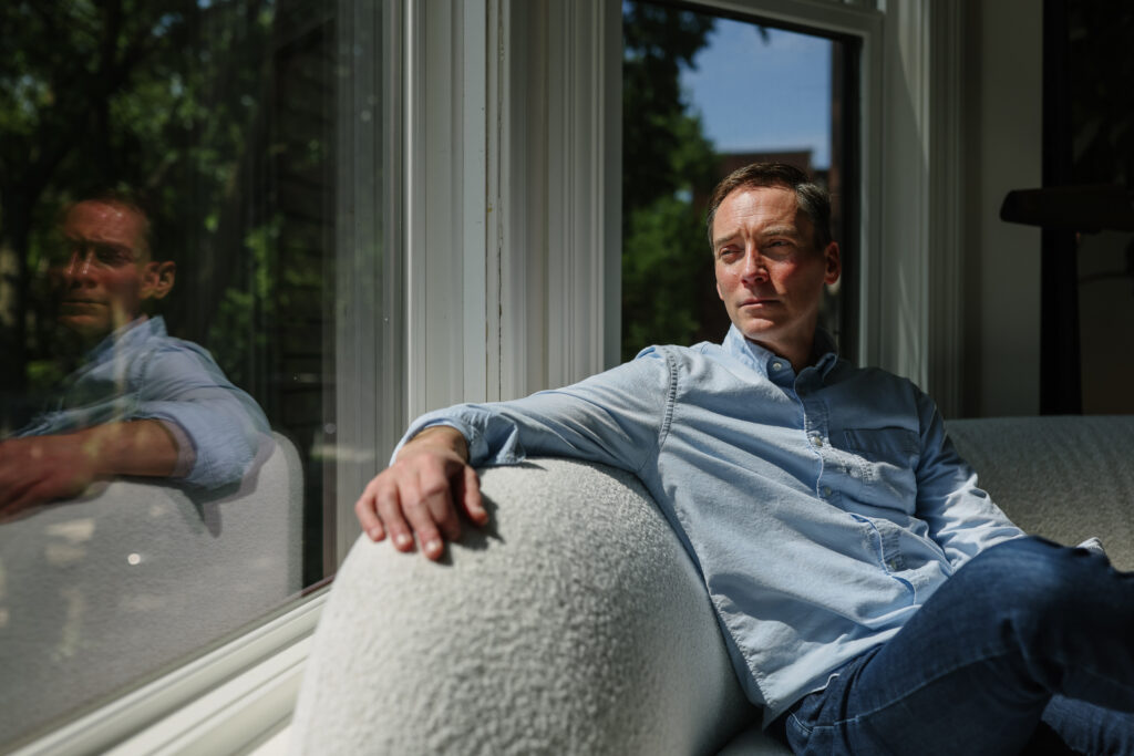 Leo Feler sits inside his home in Chicago, which was warrantlessly raided by Customs and Border Protection officers in October 2025.