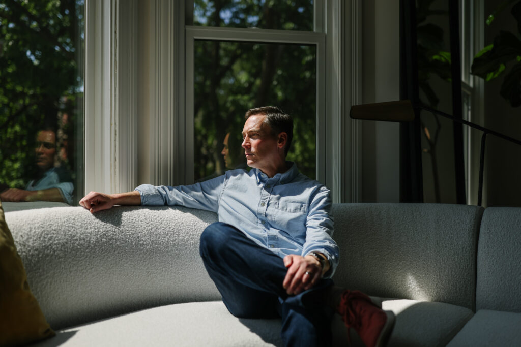 Leo Feler sits inside his home in Chicago, which was warrantlessly raided by Customs and Border Protection officers in October 2025.