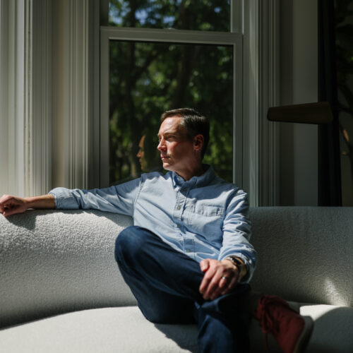 Leo Feler sits inside his home in Chicago, which was warrantlessly raided by Customs and Border Protection officers in October 2025.