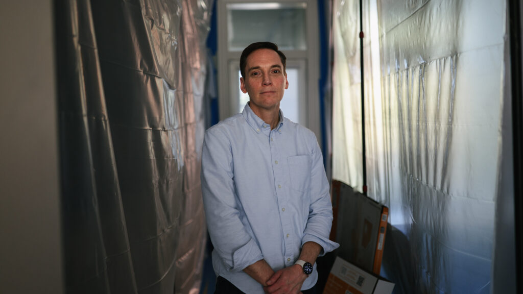 Leo Feler stands in a portion of his Chicago home that is still under construction. The home was warrantlessly raided by Customs and Border Protection officers in October 2025.