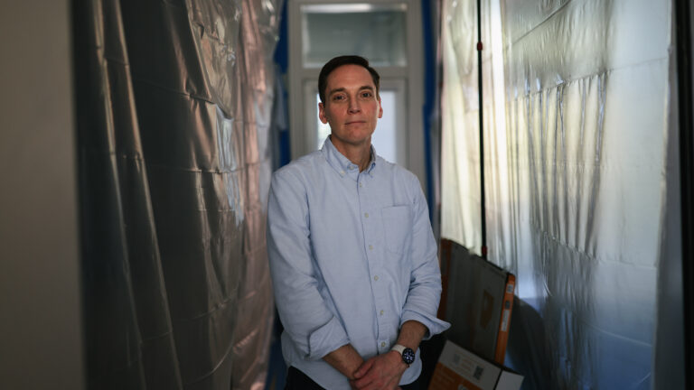 Leo Feler stands in a portion of his Chicago home that is still under construction. The home was warrantlessly raided by Customs and Border Protection officers in October 2025.