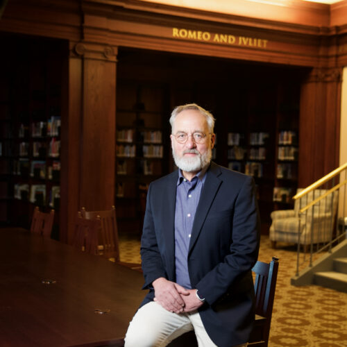 Capstone Chairman Ronald Robson sitting on a table in North Dakota library