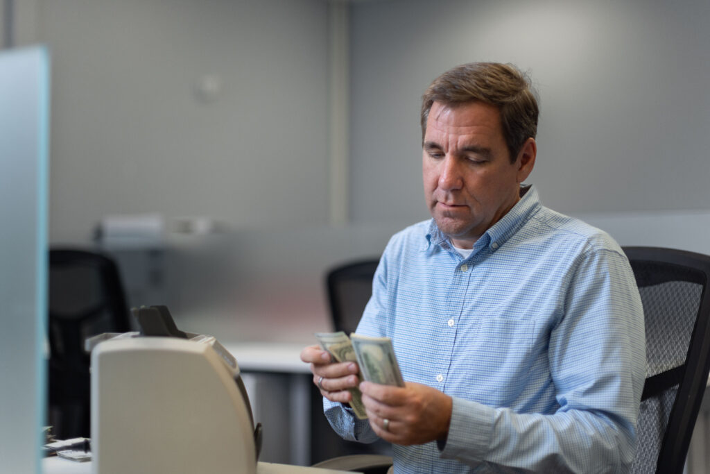 Steven Bailey counts cash inside Global Coin Logistics' office in Louisville, Kentucky.