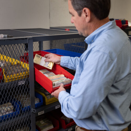 Steven Bailey looks through exotic currencies inside Global Coin Logistics' vault in Louisville, Kentucky.