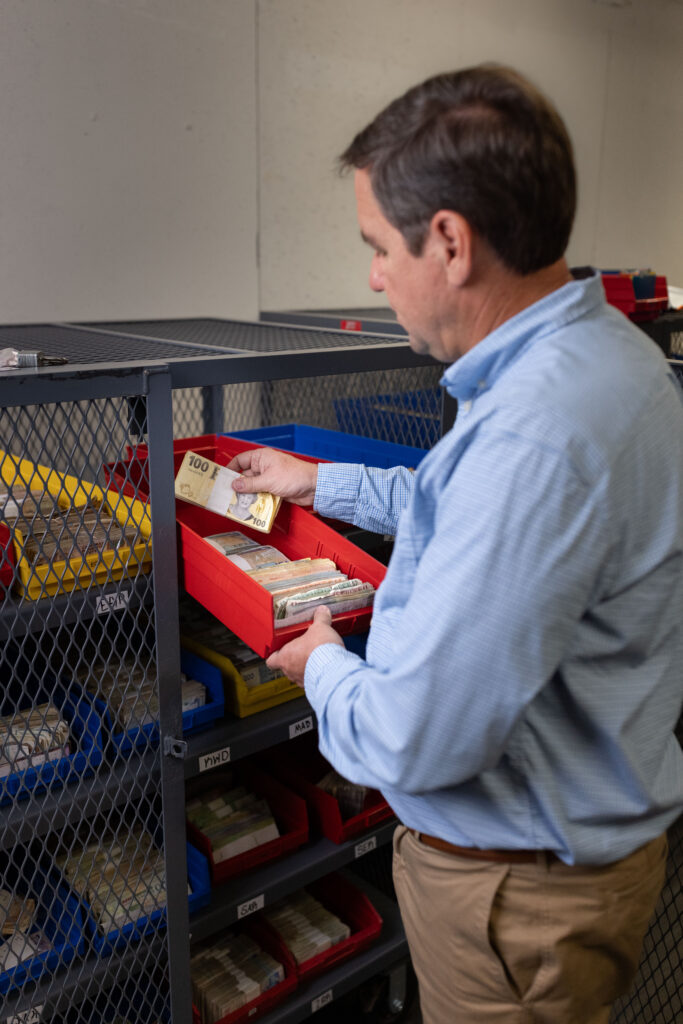 Steven Bailey looks through exotic currencies inside Global Coin Logistics' vault in Louisville, Kentucky.