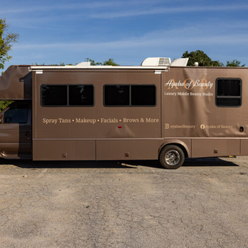 Brown RV converted into Ayaba of Beauty mobile studio offering spray tans, makeup, facials, and brows
