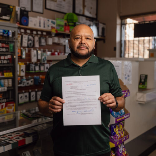 Convenience store owner holding a sealed federal search and seizure warrant document