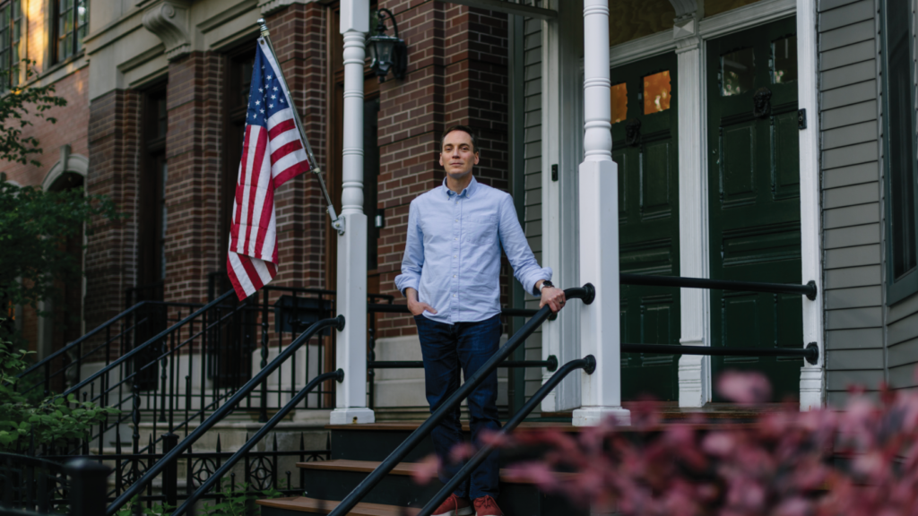 Leo Feler stands on the porch steps of his Chicago triplex that was raided by CBP officers