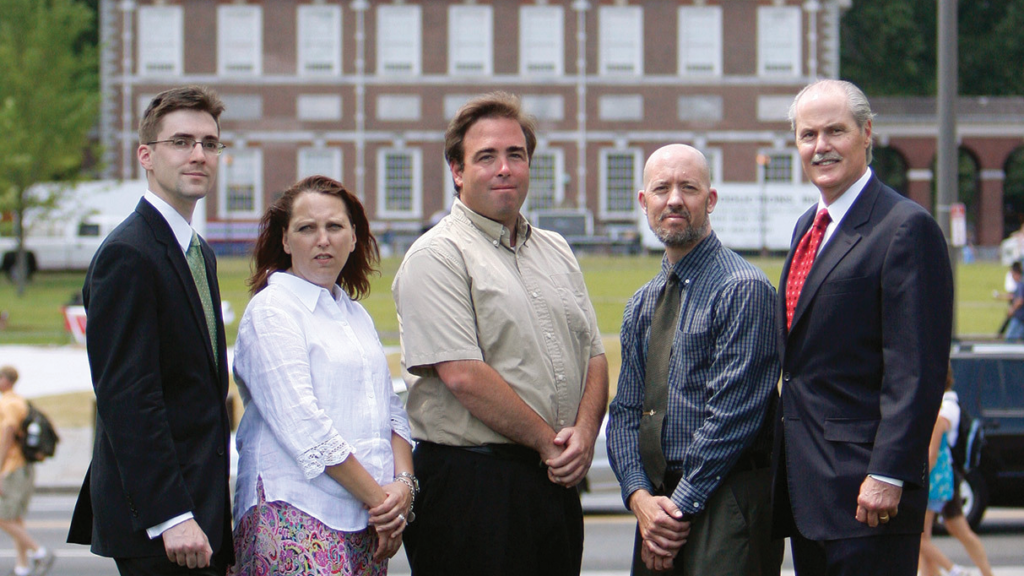 Tour guides Ann Boulais, Josh Silver, and Mike Tait stand with IJ attorneys Robert McNamara and Chip Mellor outdoors