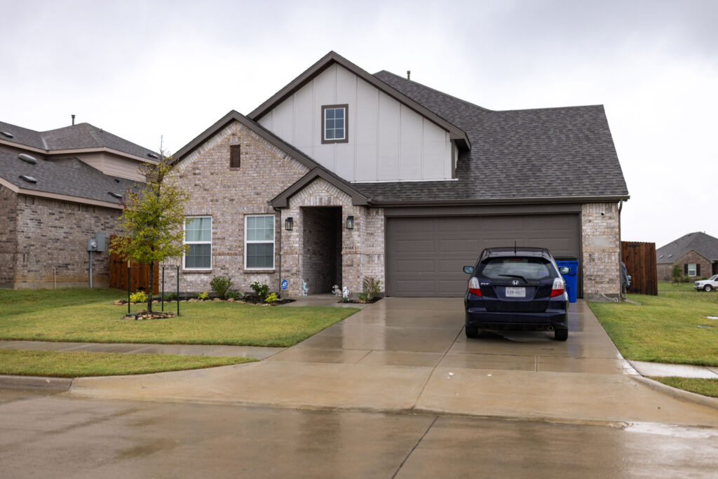 Rosi Paredes' brick home in Venus, Texas, site of her home daycare, with car in driveway