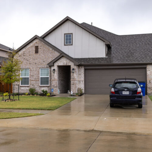 Rosi Paredes' brick home in Venus, Texas, site of her home daycare, with car in driveway