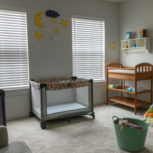 Nursery with cribs, changing table, and toys at Rosi Paredes's Venus, Texas home daycare