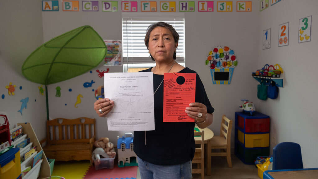 Rosi Paredes Garcia holds state child care license and Venus, TX violation notice in her home daycare