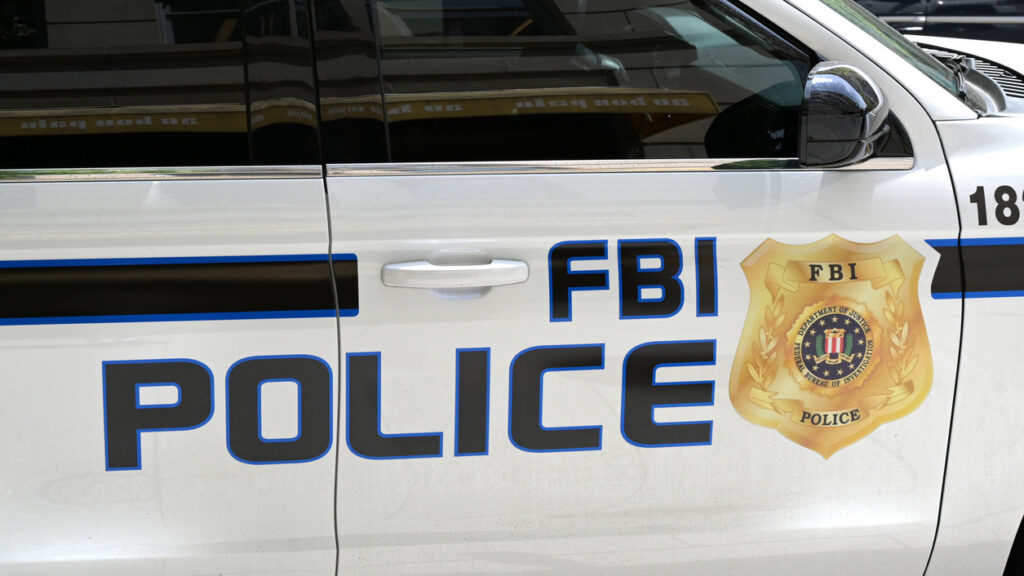 Close-up of FBI Police badge and lettering on the door of a patrol car